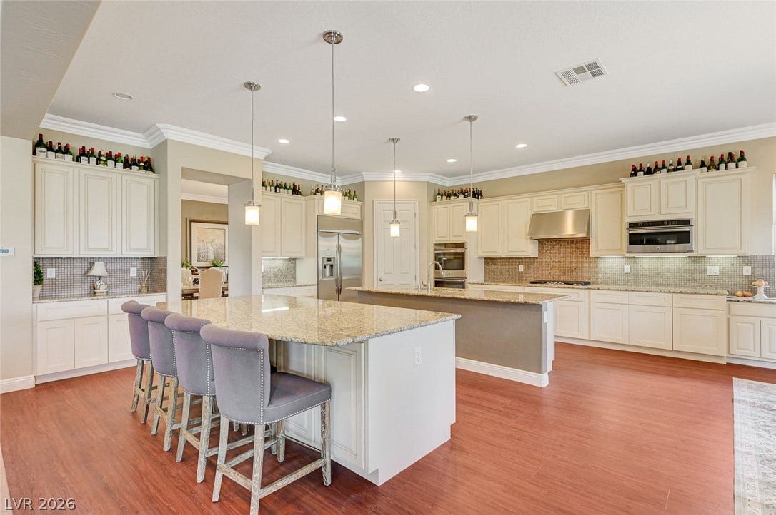 Gleaming hardwood floors and stone countertops anchor this gourmet culinary space.
