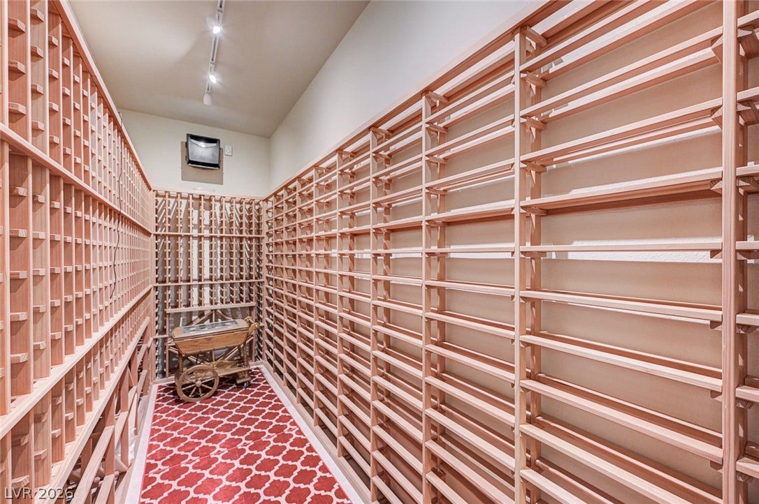 Floor-to-ceiling wooden racks provide extensive storage in this dedicated climate-controlled space.