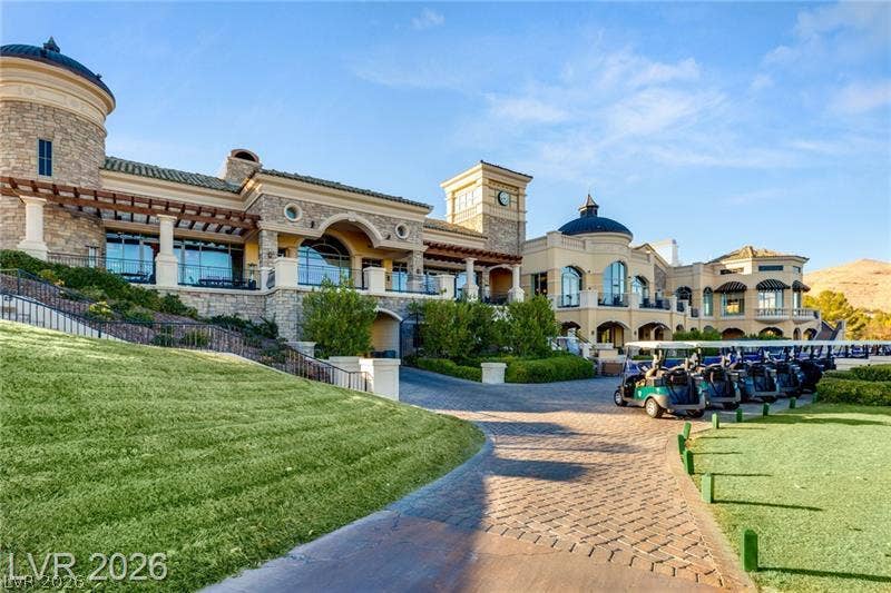 Stately architectural details and manicured grounds define this impressive estate facade.
