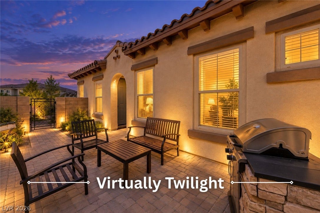 Warm exterior uplighting illuminates the paved patio under a twilight sky.