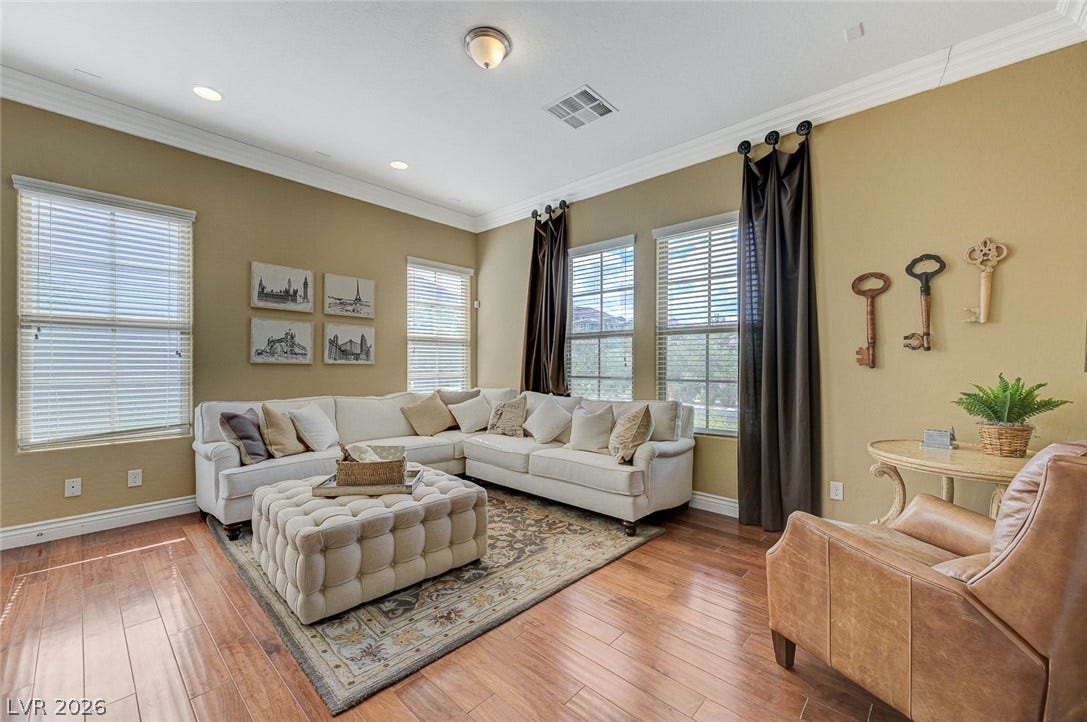 Gleaming hardwood floors and classic crown molding elevate this welcoming living space.