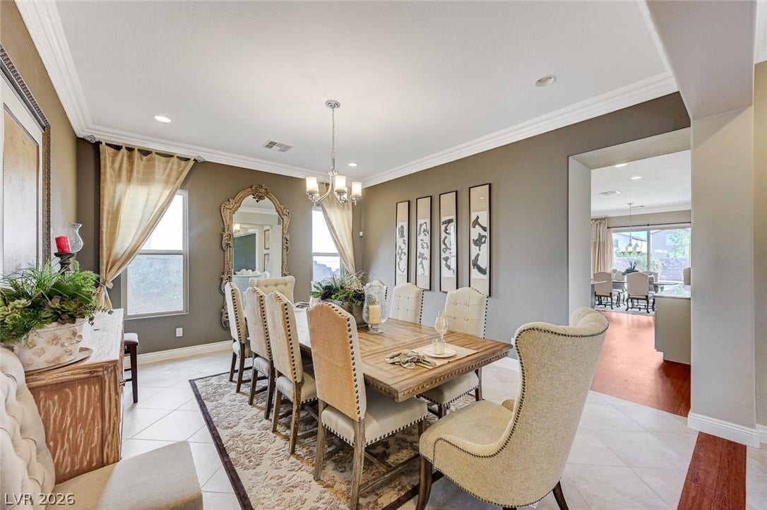 Crown molding and tiled floors define this formal dining space set adjacent to the kitchen.