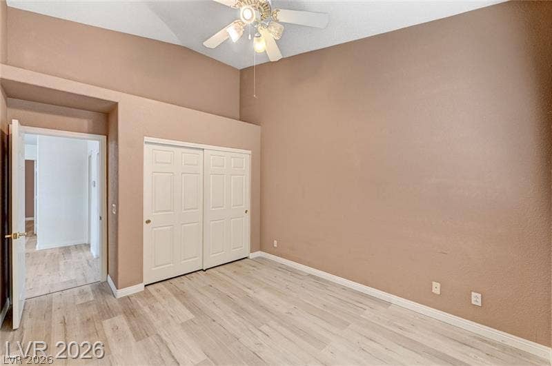 3327 Erva Street, #207, Las Vegas, NV 89117 High vaulted ceilings and wood-style flooring elevate this comfortable bedroom space.