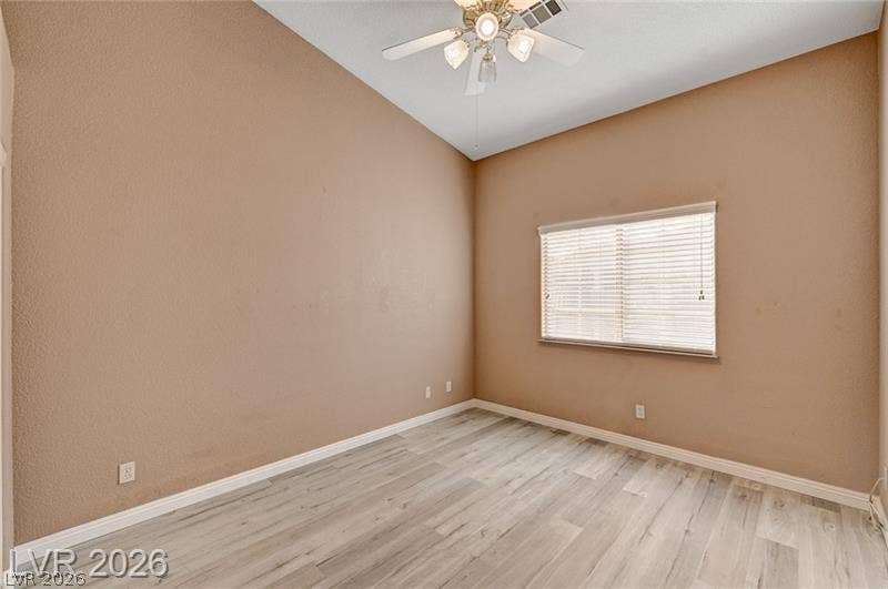 3327 Erva Street, #207, Las Vegas, NV 89117 High vaulted ceilings and wood-style flooring elevate this versatile secondary bedroom space.