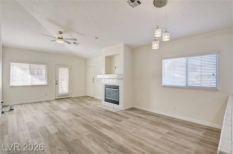 3327 Erva Street, #207, Las Vegas, NV 89117 An open layout flows past a tile fireplace and resilient plank flooring.