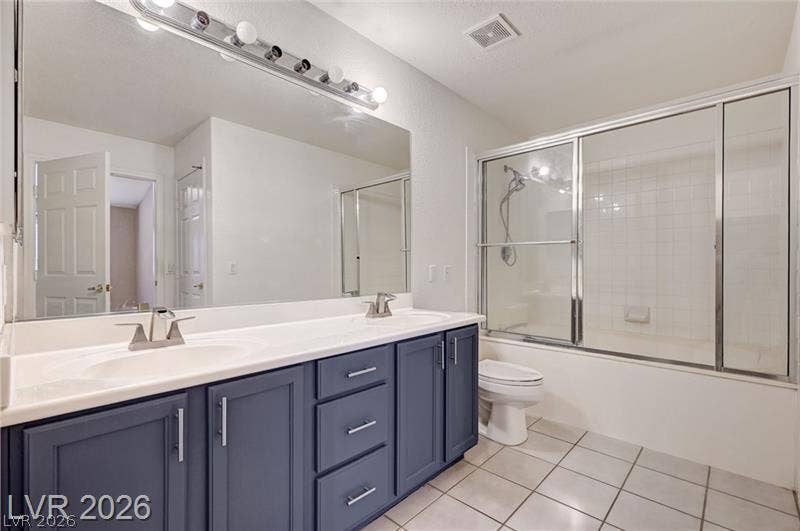 3327 Erva Street, #207, Las Vegas, NV 89117 A spacious double vanity and tile flooring highlight this classic bathroom layout.