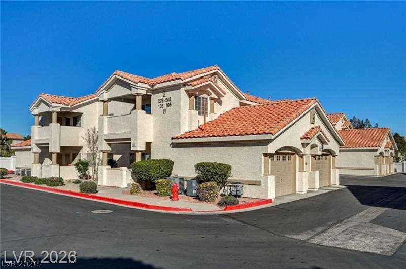 3327 Erva Street, #207, Las Vegas, NV 89117 Mediterranean style architecture defined by classic stucco walls and distinctive red tile roofing.