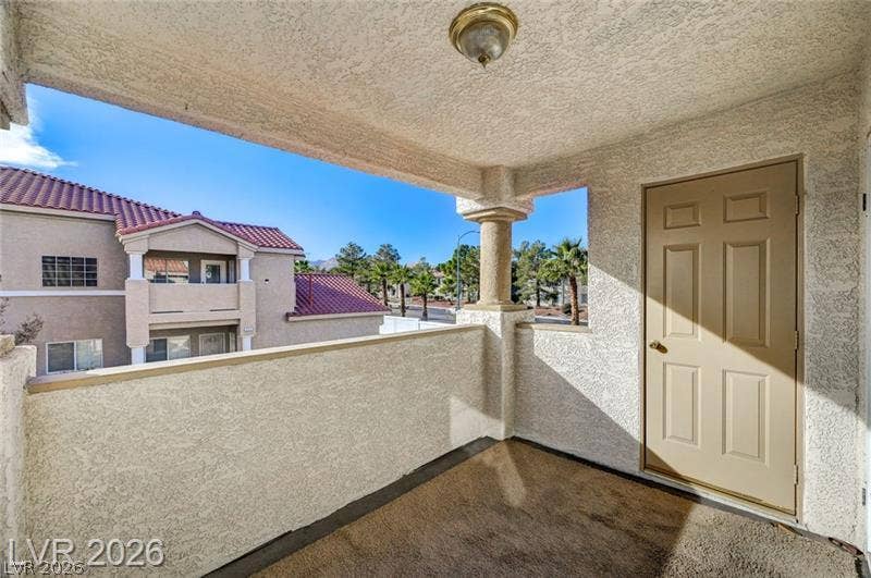 3327 Erva Street, #207, Las Vegas, NV 89117 An elevated covered balcony overlooks the surrounding neighborhood.