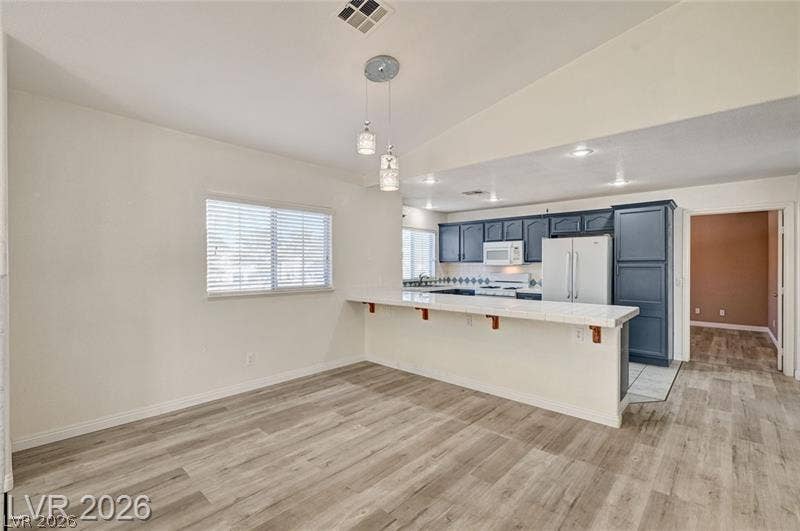 3327 Erva Street, #207, Las Vegas, NV 89117 Casual dining space opens directly to the kitchen with wood-look flooring and breakfast bar.