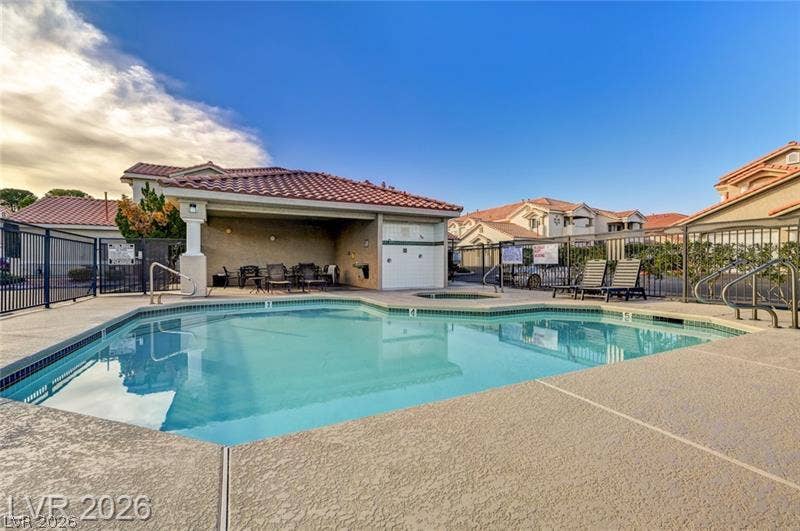 3327 Erva Street, #207, Las Vegas, NV 89117 Clear blue waters ripple under a tiled cabana and sprawling neighborhood skies.