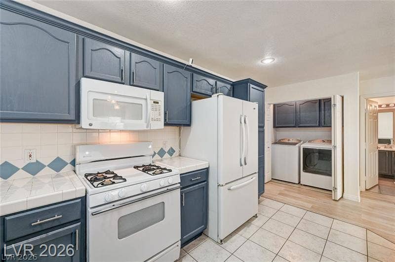 3327 Erva Street, #207, Las Vegas, NV 89117 Tiled flooring sets a classic foundation for the kitchen and adjoining laundry area.