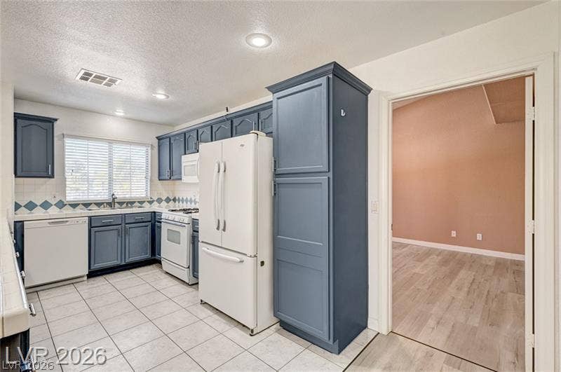 3327 Erva Street, #207, Las Vegas, NV 89117 Tiled flooring and recessed lighting define this kitchen space adjacent to the main living area.