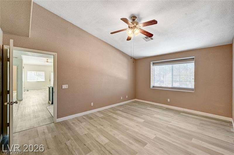 3327 Erva Street, #207, Las Vegas, NV 89117 Vaulted ceilings and wood-look flooring enhance the character of this versatile living space.