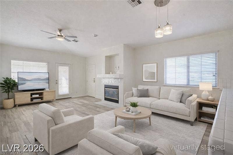 3327 Erva Street, #207, Las Vegas, NV 89117 Smooth tile floors and a classic fireplace define this bright living space.