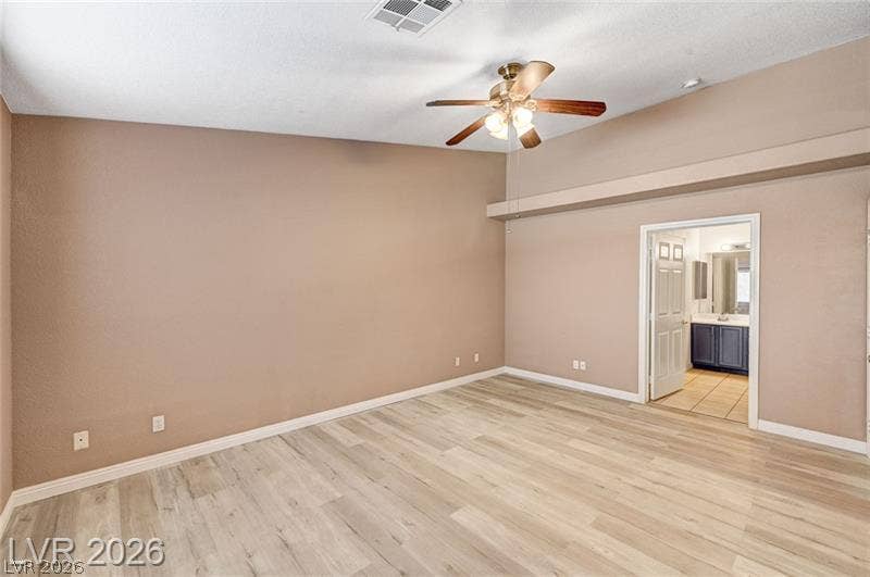 3327 Erva Street, #207, Las Vegas, NV 89117 Vaulted ceilings and wood-look flooring enhance this spacious bedroom suite with an attached bath.