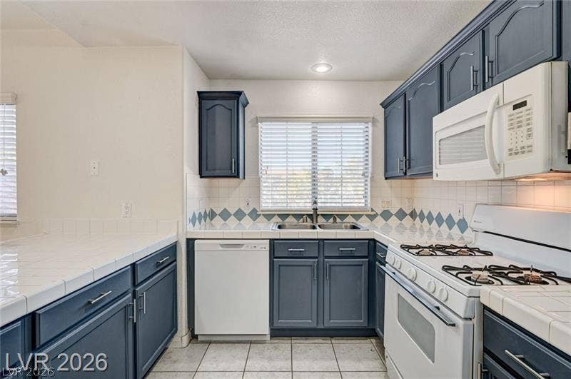 3327 Erva Street, #207, Las Vegas, NV 89117 Tiled countertops and classic cabinetry bring functional charm to this well-appointed cooking space.