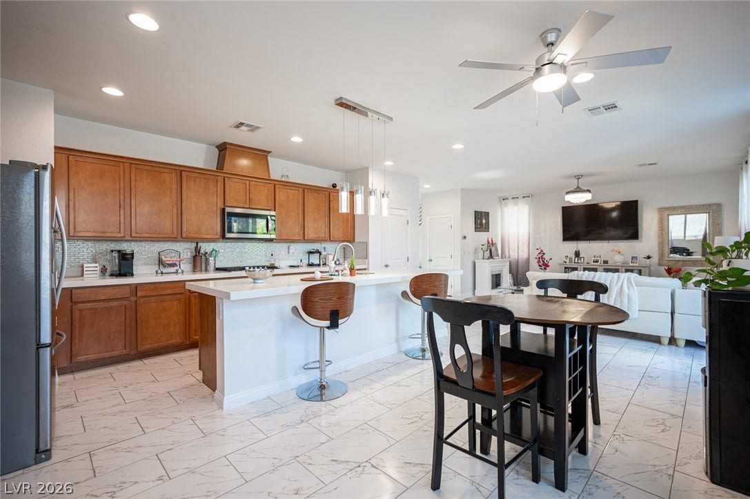 An open concept floor plan seamlessly connects the kitchen to the bright living space.