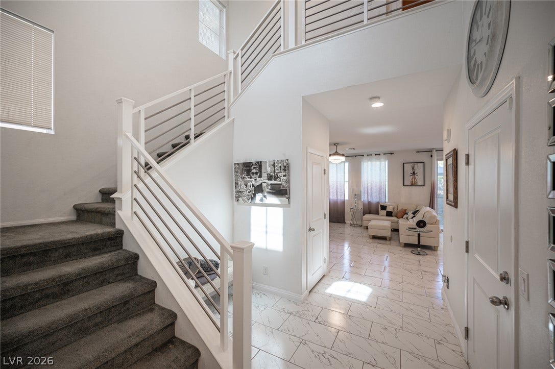 Polished tile flooring and an open-concept layout welcome guests into this spacious home.