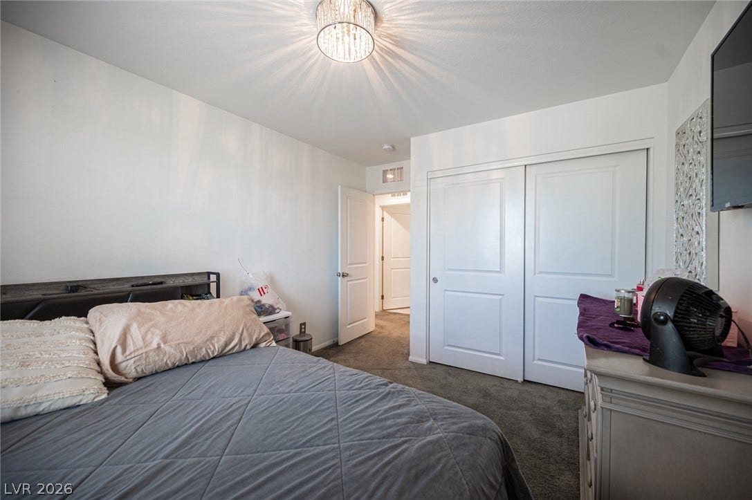 Plush carpeting and a spacious sliding-door closet define this comfortable bedroom.