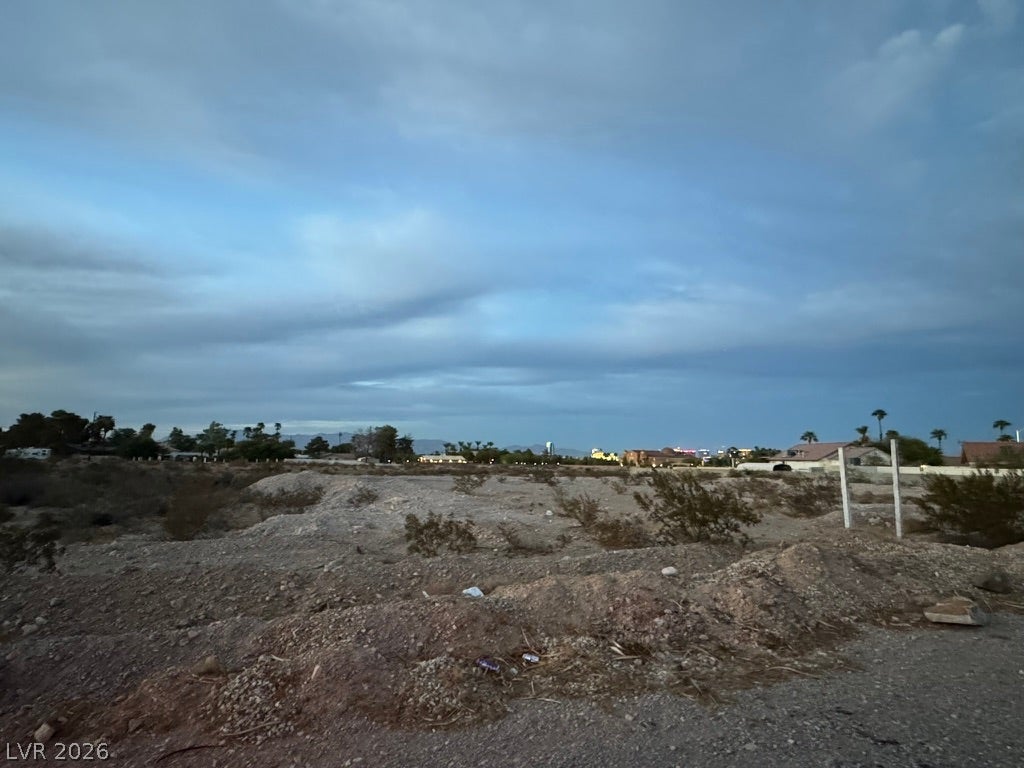 Patrick, Las Vegas, NV 89118 Distant city lights shimmer along the horizon beneath an expansive evening sky.
