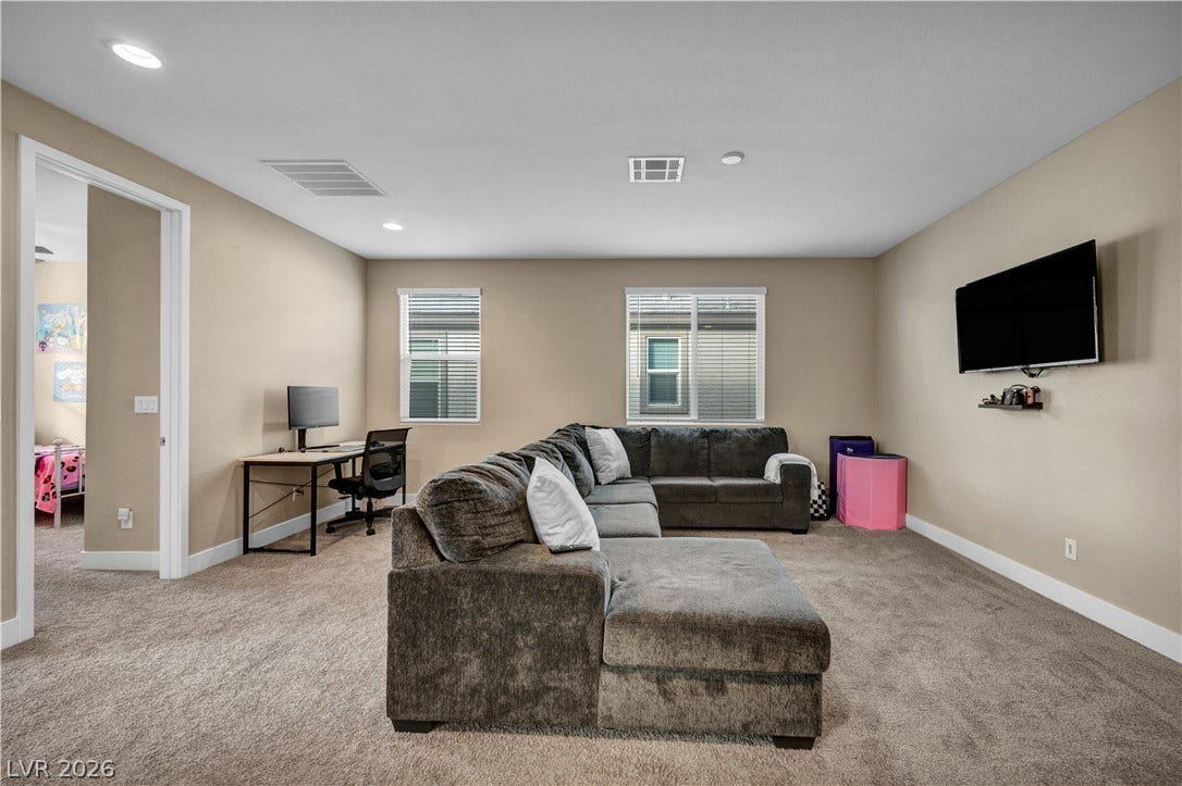 7128 Port Stephens Street, North Las Vegas, NV 89084 Recessed lighting and soft carpeting create a comfortable living space with ample wall space.