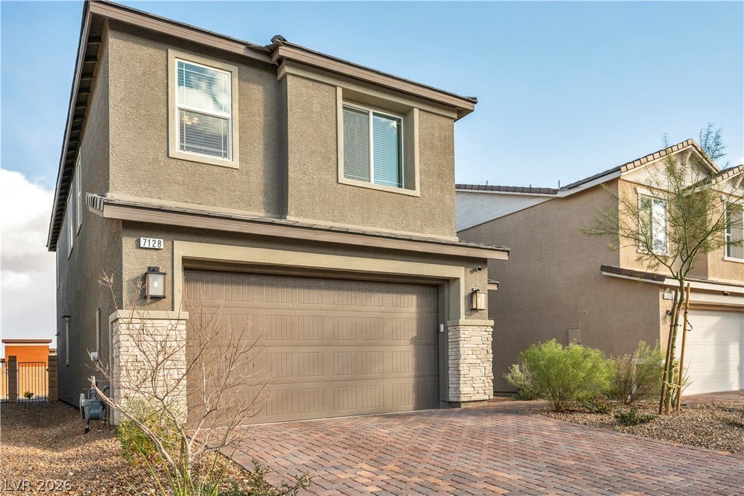 7128 Port Stephens Street, North Las Vegas, NV 89084 Stucco and stone exterior details define the facade of this two-story residential design.