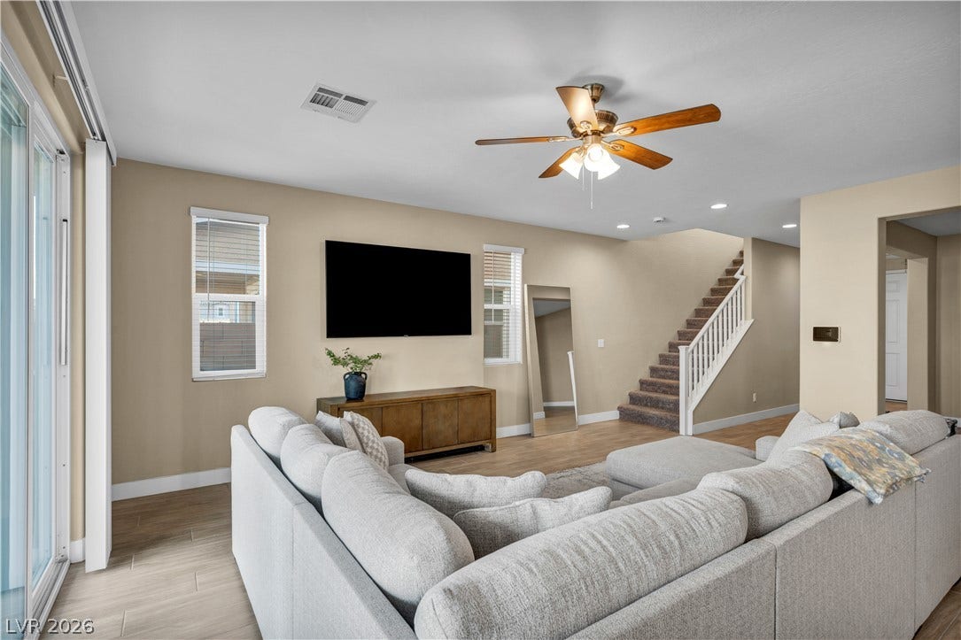7128 Port Stephens Street, North Las Vegas, NV 89084 An inviting open floorplan connects the comfortable living area with the upper-level staircase.