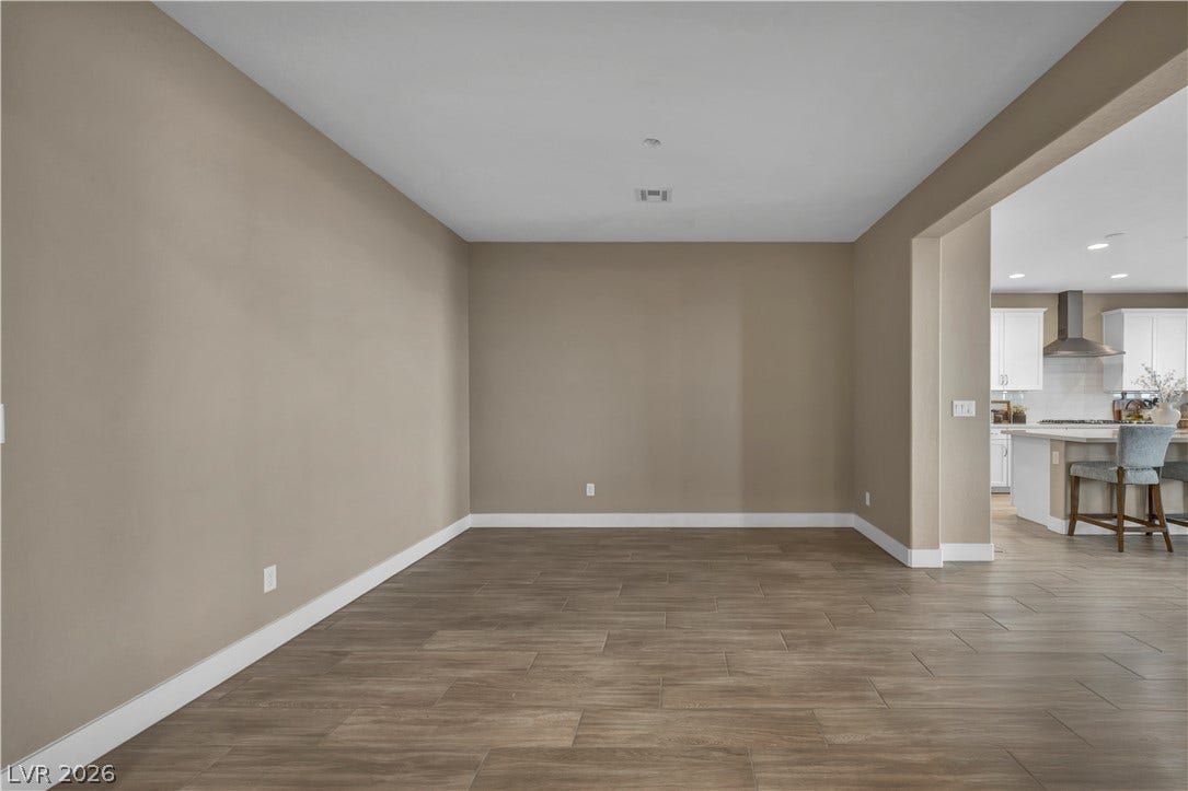 7128 Port Stephens Street, North Las Vegas, NV 89084 Seamless tile flooring flows from this versatile open space directly into the kitchen.