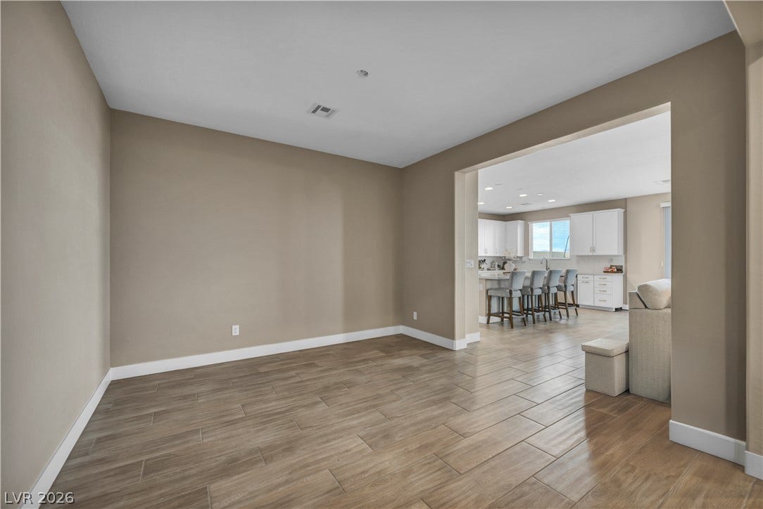 7128 Port Stephens Street, North Las Vegas, NV 89084 Wood-look tile flooring flows throughout this versatile open-concept living space.