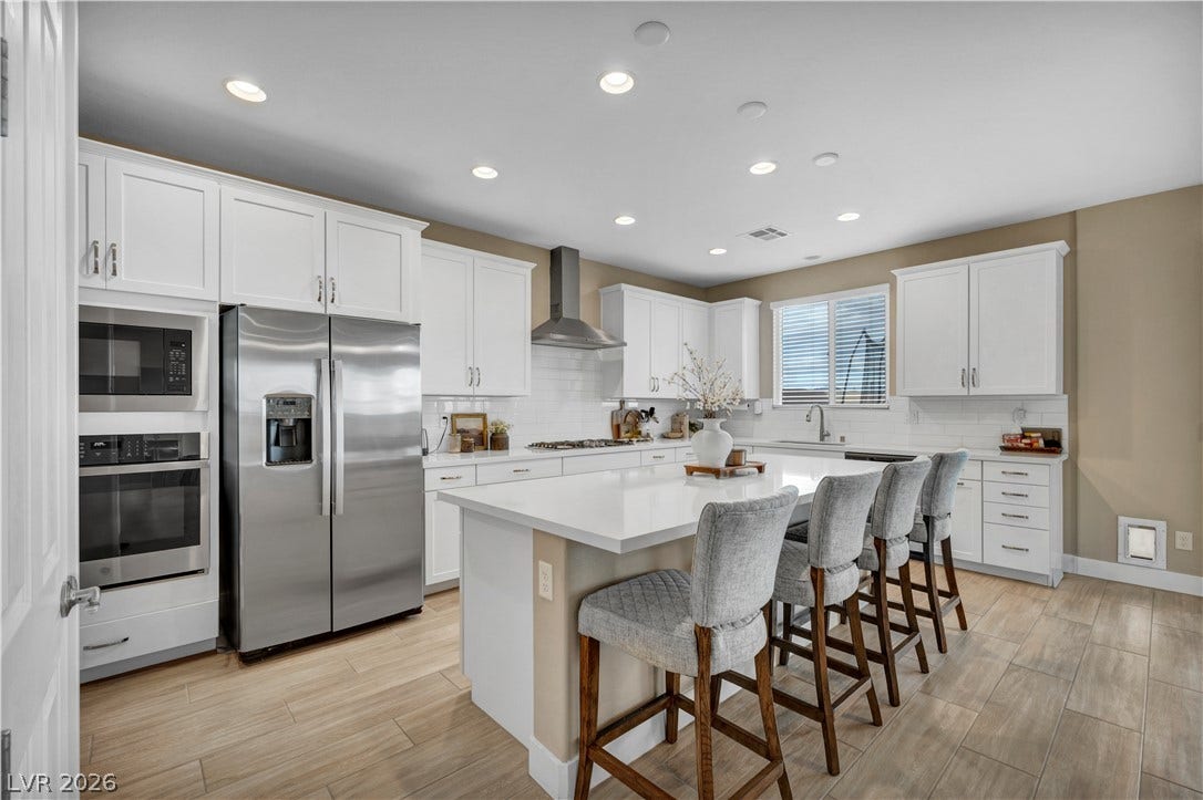 7128 Port Stephens Street, North Las Vegas, NV 89084 Recessed lighting illuminates this modern culinary space anchored by a central island.