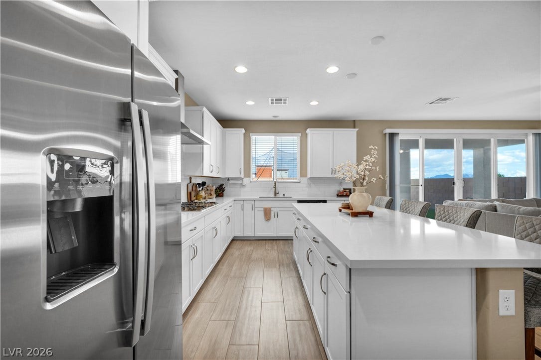 7128 Port Stephens Street, North Las Vegas, NV 89084 An open kitchen layout showcases sleek countertops and a spacious central island.