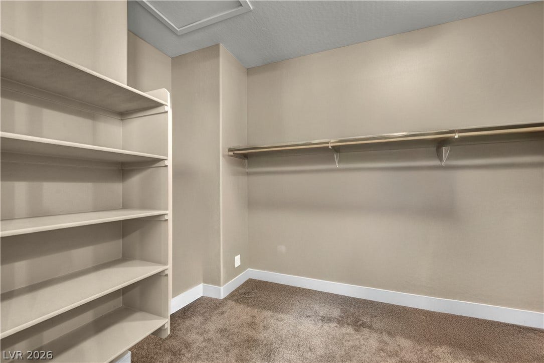 7128 Port Stephens Street, North Las Vegas, NV 89084 Ample built-in shelving and hanging rods maximize storage in this carpeted closet.