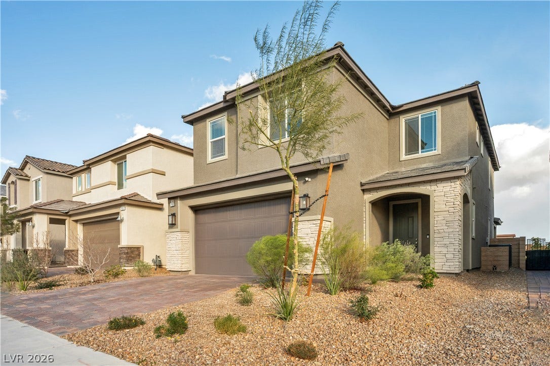 7128 Port Stephens Street, North Las Vegas, NV 89084 Clean lines and a desert landscape frame this two-story contemporary home with stone accents.