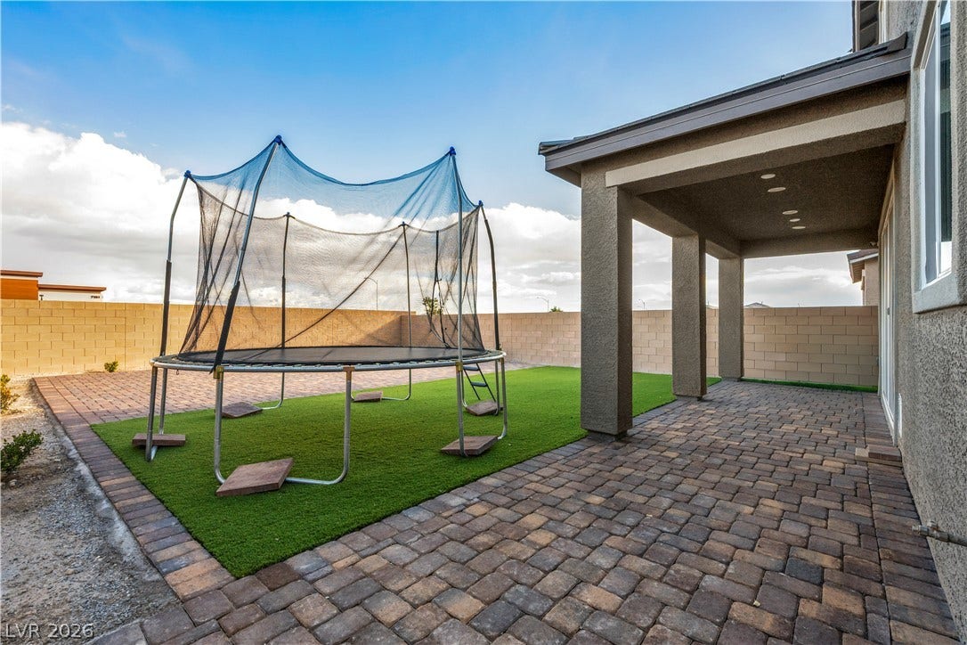 7128 Port Stephens Street, North Las Vegas, NV 89084 An inviting covered patio opens to a low-maintenance yard enclosed by a block privacy wall.