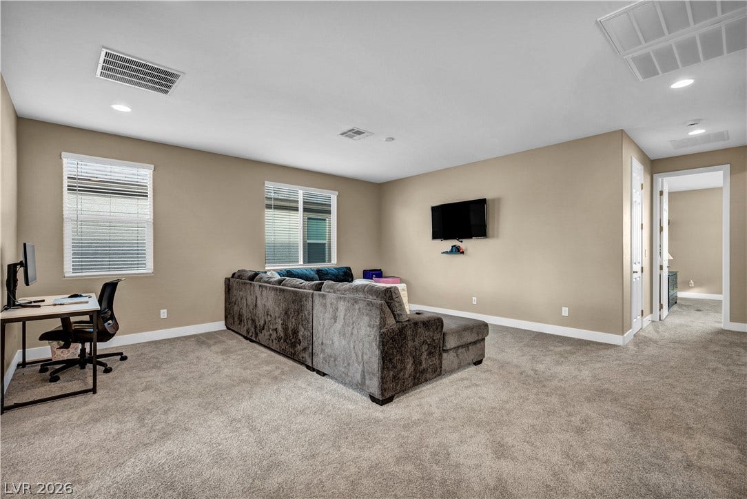 7128 Port Stephens Street, North Las Vegas, NV 89084 Generous proportions and soft carpeting define this versatile upper-level living space.