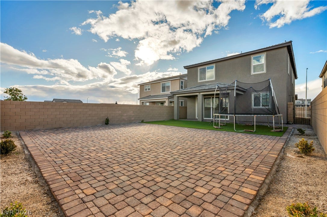 7128 Port Stephens Street, North Las Vegas, NV 89084 A spacious brick paver patio highlights the low-maintenance backyard of this modern home.