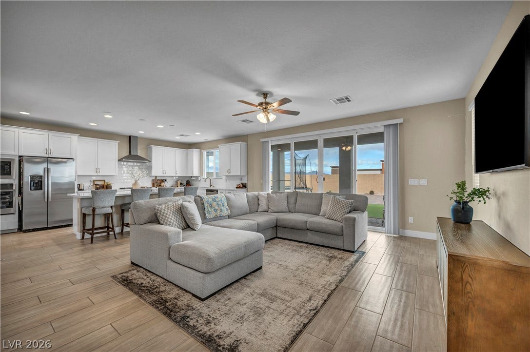 7128 Port Stephens Street, North Las Vegas, NV 89084 An open-concept living area seamlessly connects to the kitchen over tile flooring.