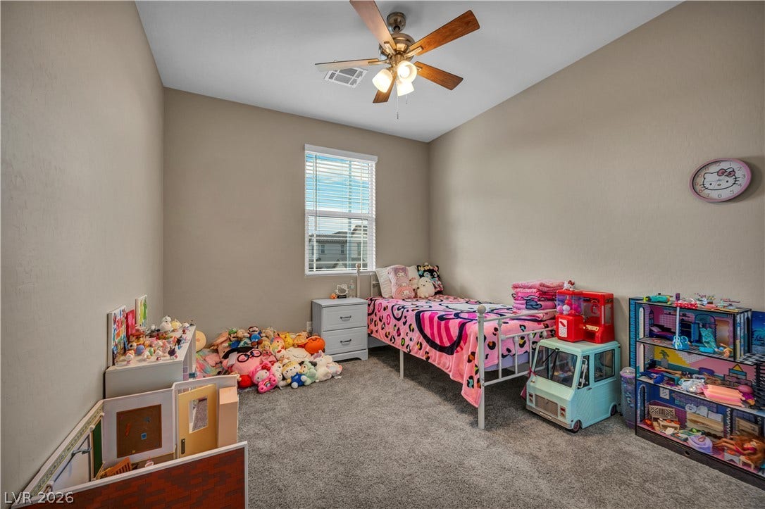 7128 Port Stephens Street, North Las Vegas, NV 89084 Smooth walls and wall-to-wall carpeting define this comfortable secondary bedroom space.