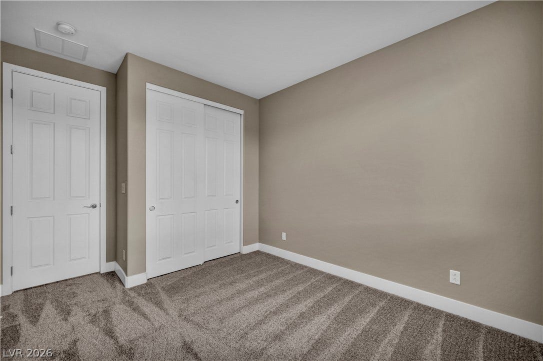 7128 Port Stephens Street, North Las Vegas, NV 89084 Plush wall-to-wall carpeting and clean baseboards define this versatile secondary bedroom space.
