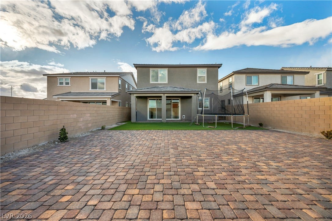 7128 Port Stephens Street, North Las Vegas, NV 89084 A spacious brick-paved patio area extends from the rear of this modern two-story home.