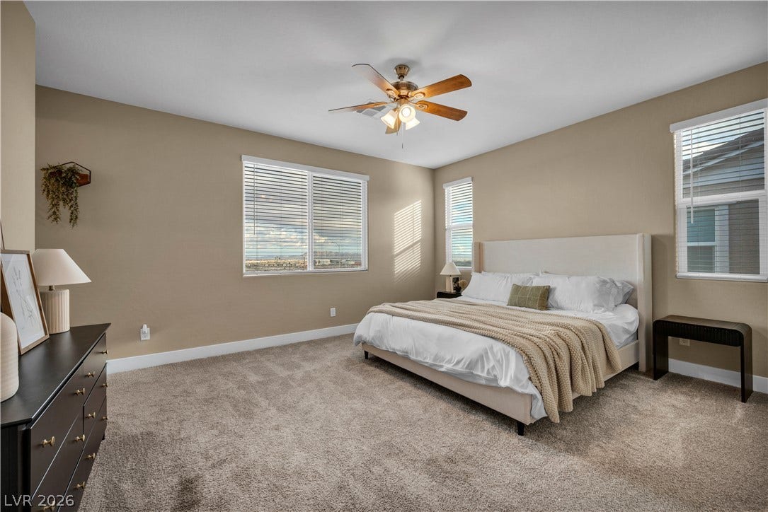 7128 Port Stephens Street, North Las Vegas, NV 89084 Plentiful windows fill this bedroom with natural light highlighting the plush carpeted floor.