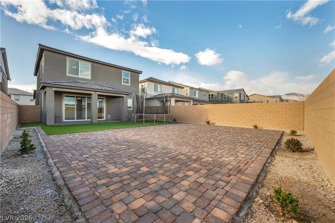 7128 Port Stephens Street, North Las Vegas, NV 89084 An expansive paved patio highlights the low-maintenance backyard enclosed by block fencing.