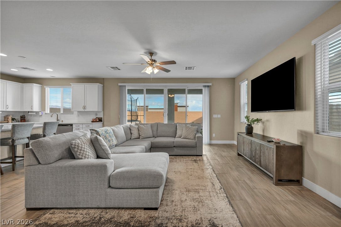7128 Port Stephens Street, North Las Vegas, NV 89084 An open floorplan seamlessly connects the comfortable living area with the adjacent kitchen space.