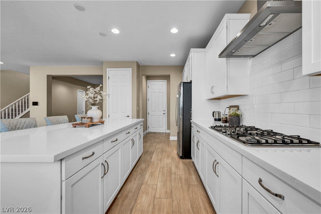 7128 Port Stephens Street, North Las Vegas, NV 89084 Gleaming stone countertops and crisp cabinetry anchor this highly functional workspace.