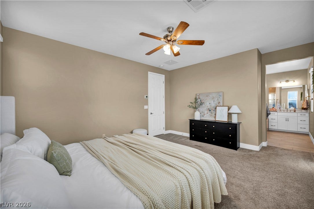 7128 Port Stephens Street, North Las Vegas, NV 89084 Plush carpeting and an adjacent bathroom suite define this relaxing master bedroom retreat.