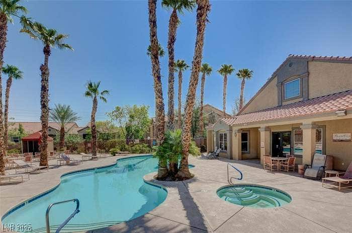 2300 E Silverado Ranch Boulevard, #1077, Las Vegas, NV 89183 Soaring palm trees frame a sparkling community pool and spa patio adjacent to the clubhouse.