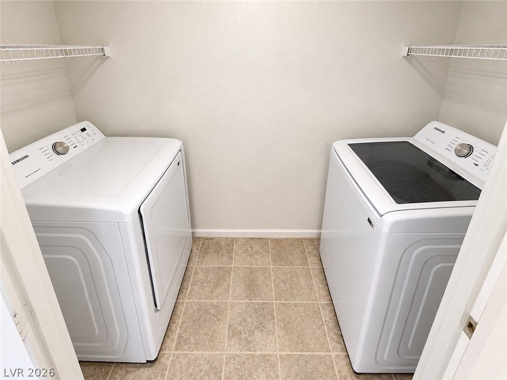 2300 E Silverado Ranch Boulevard, #1077, Las Vegas, NV 89183 Functional laundry space features durable tile flooring and wire shelving above the appliances.