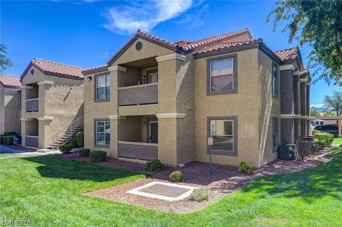 2300 E Silverado Ranch Boulevard, #1077, Las Vegas, NV 89183 Spanish tile roofs and private balconies define the exterior of these multi-level residential structures.