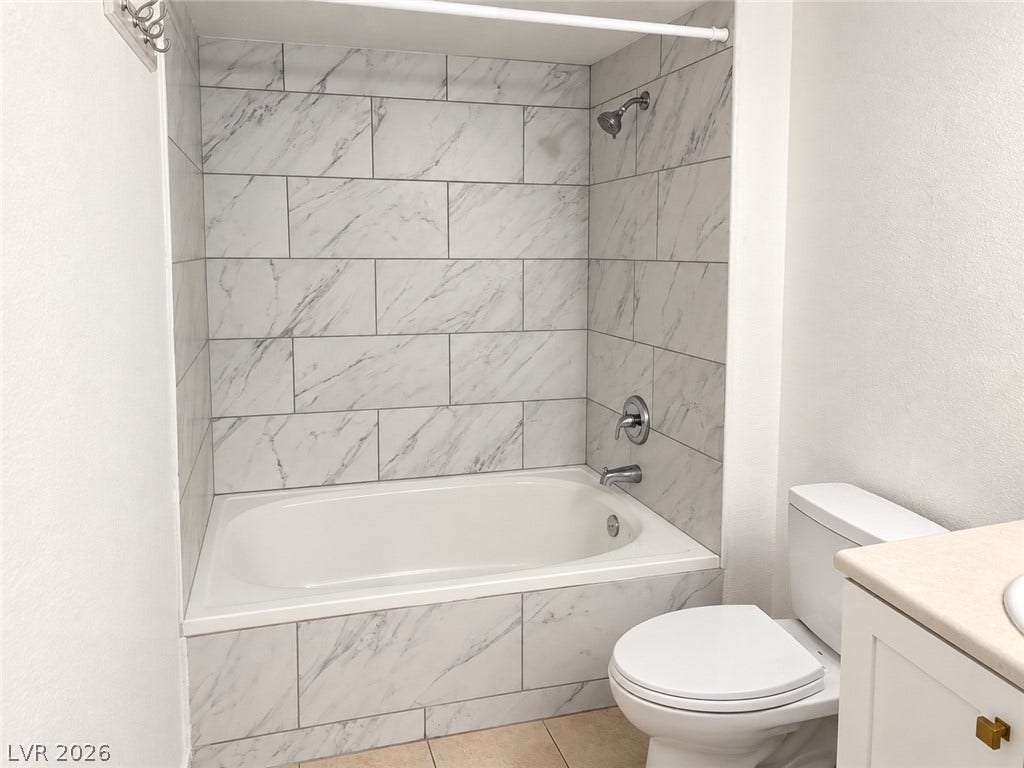 2300 E Silverado Ranch Boulevard, #1077, Las Vegas, NV 89183 Elegant tile surrounds the deep soaking tub in this updated bathroom space.