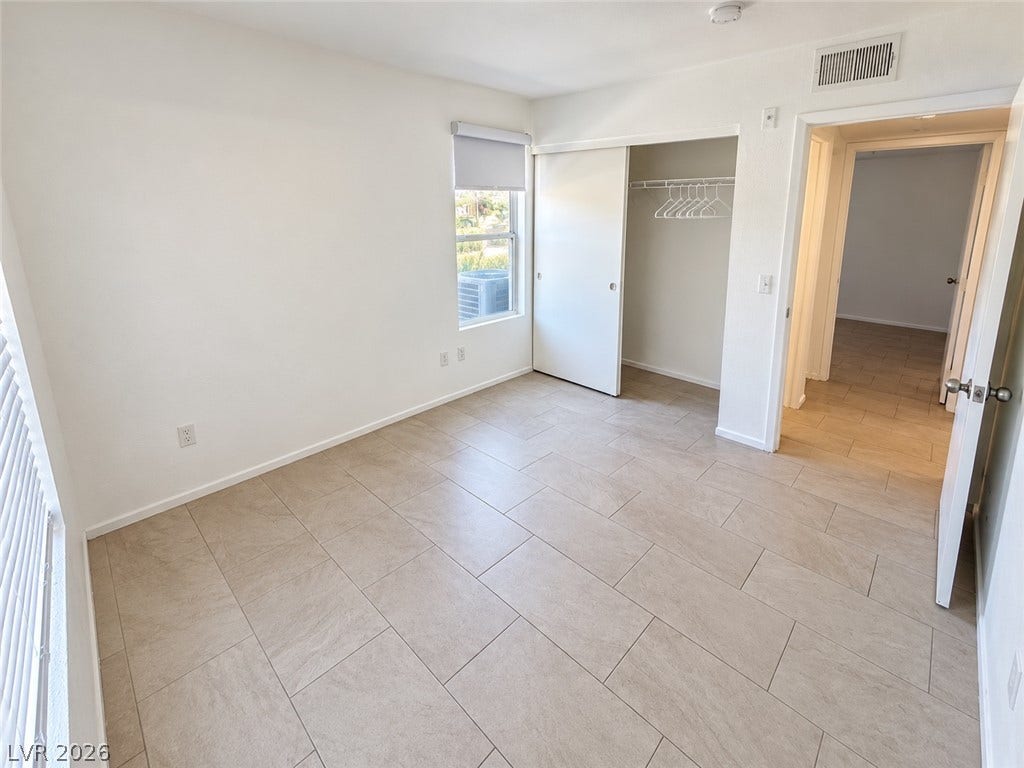 2300 E Silverado Ranch Boulevard, #1077, Las Vegas, NV 89183 Tiled flooring and a built-in closet with sliding doors anchor this versatile space.